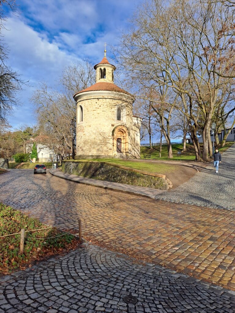 A small historic church on a cobblestone street.